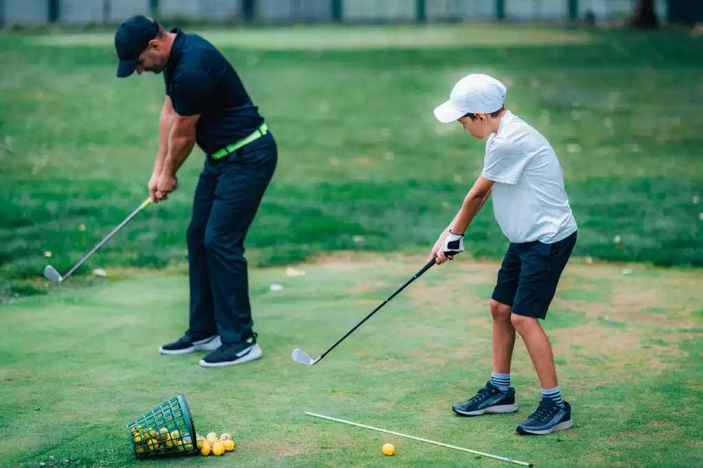 golf-lessons-a-golf-instructor-and-a-boy-practici-2026-03-08-23-50-34-utc