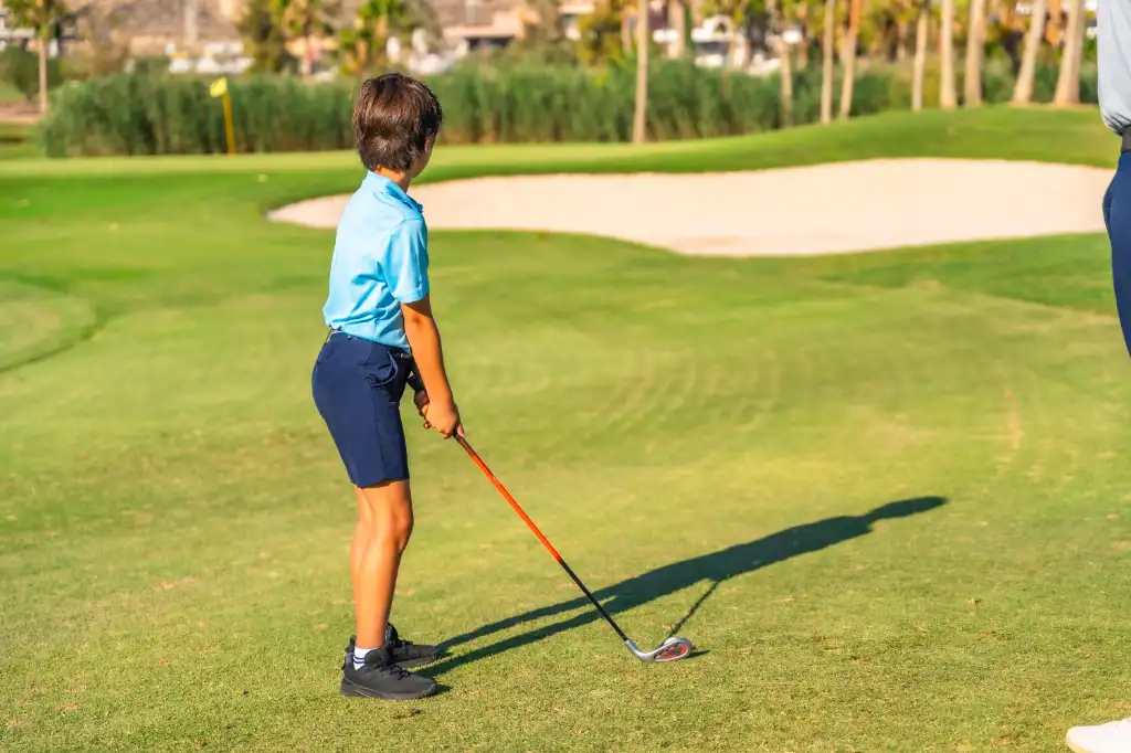 rear-view-of-a-boy-focus-about-to-swinging-golf-2026-03-16-02-45-35-utc